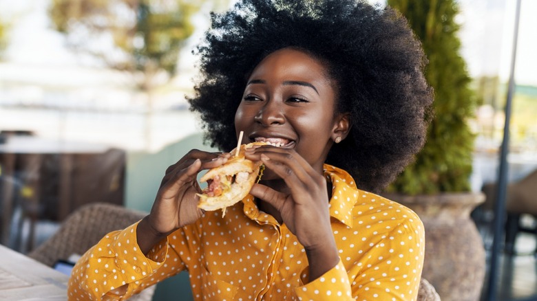 Woman eating in her kitchen