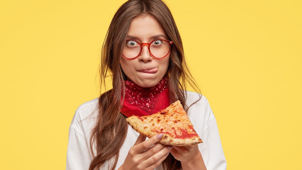 woman eating pizza