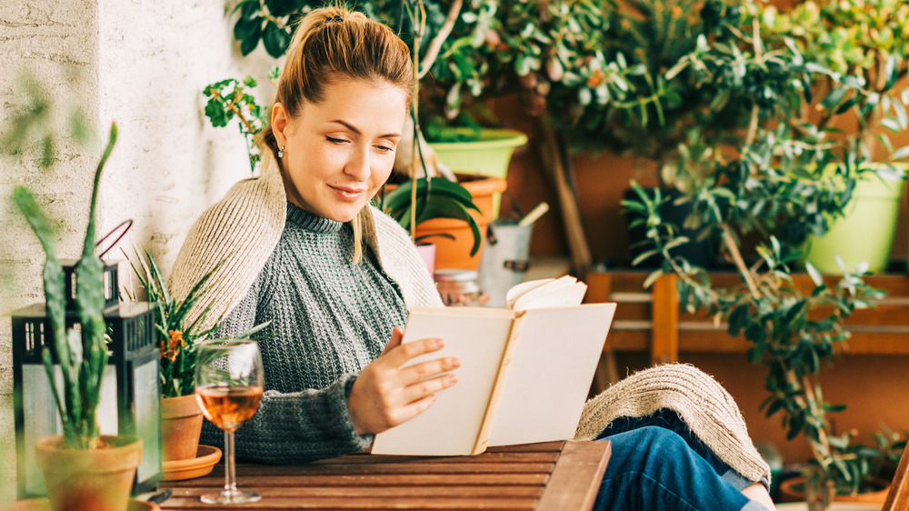 Woman drinking a glass of wine outside