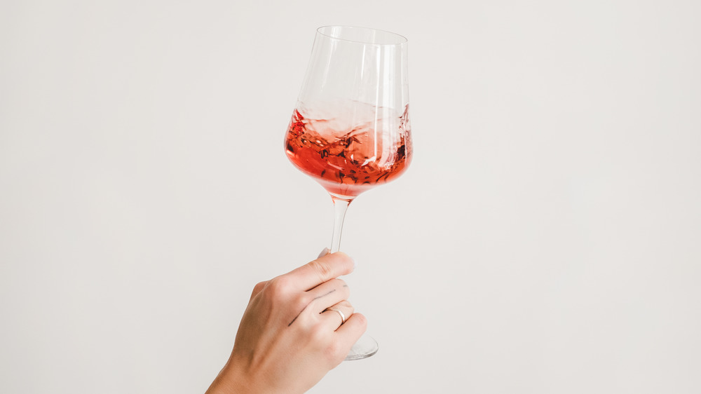 Someone holding a glass of wine