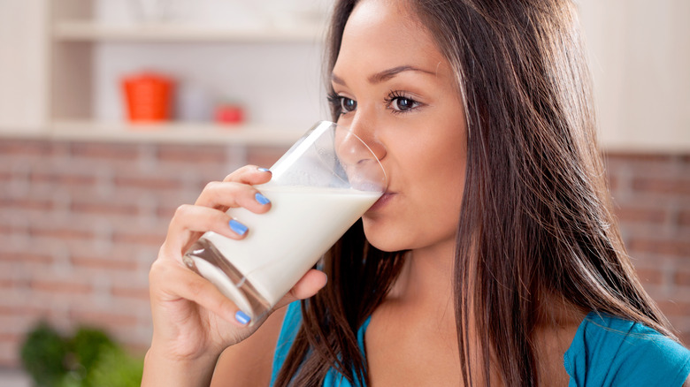 Woman drinking glass of milk