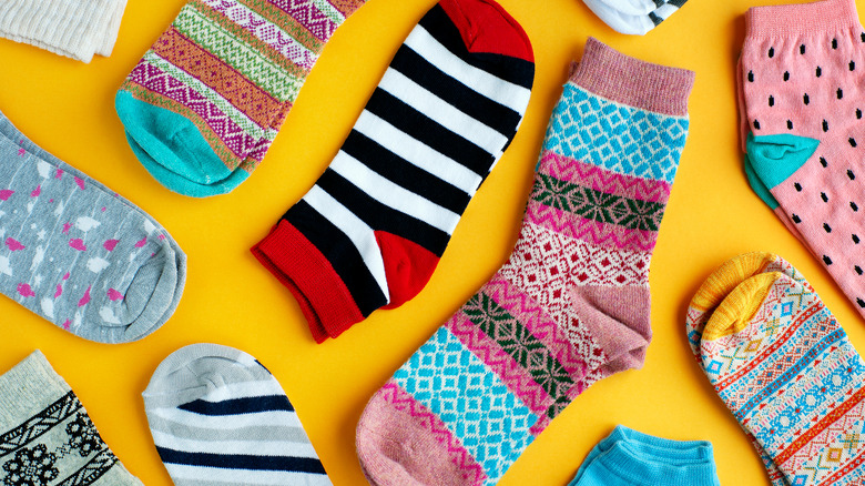 Colorful socks on yellow background