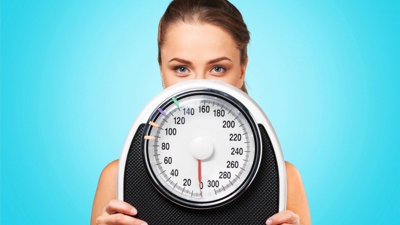 woman with scale weight loss