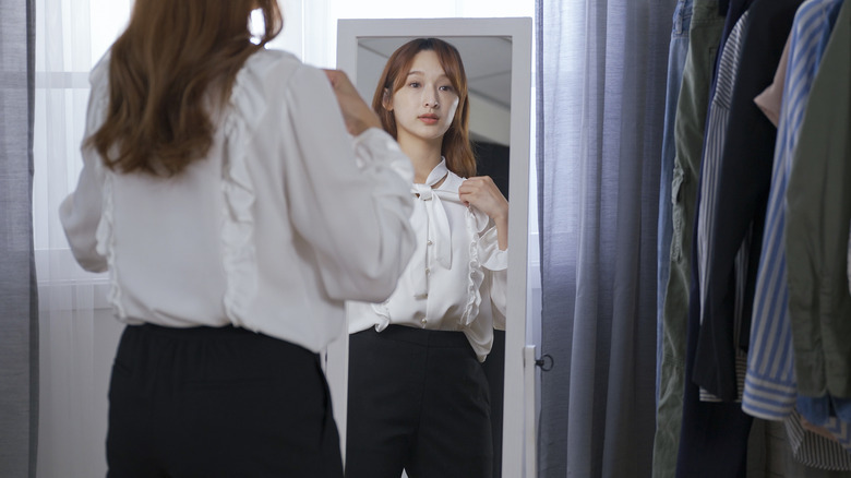 A woman adjusts her outfit