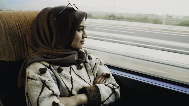 Woman on bus looking out window