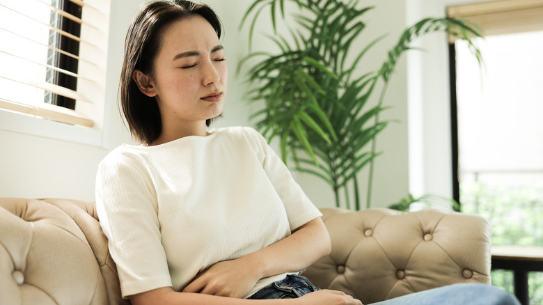 Woman holding stomach