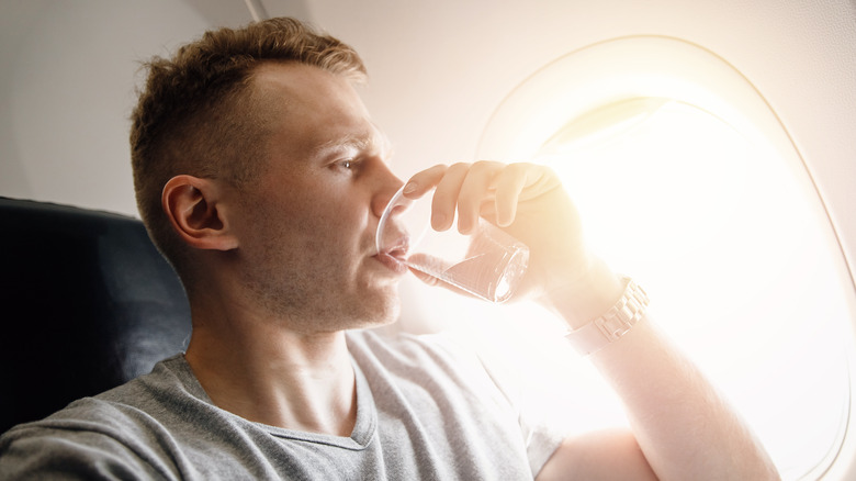 Airplane passenger drinking water