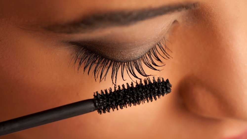 Woman applying mascara