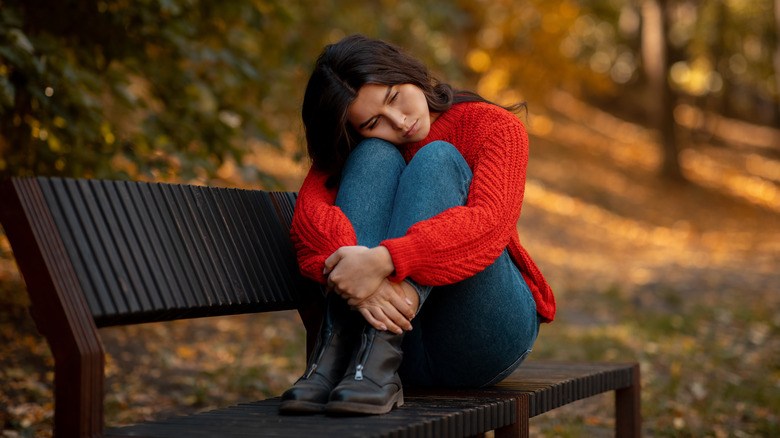 Worried woman on couch