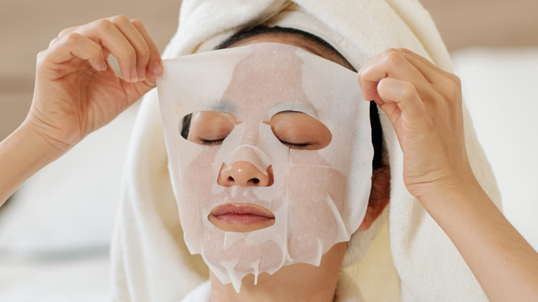 Woman smiling with a skincare mask