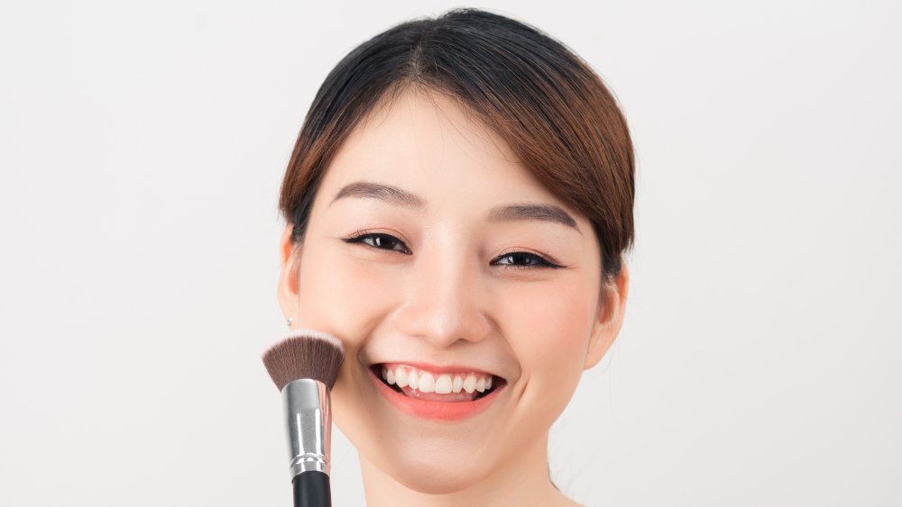 Woman applying face powder