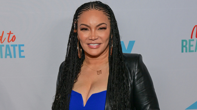 Egypt Sherrod wearing a blue outfit under a black leather jacket