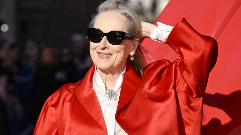 Meryl Streep red jacket, white blouse, black sunglasses