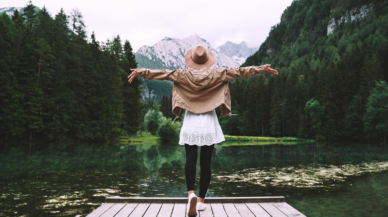 woman standing at the edge of a dock