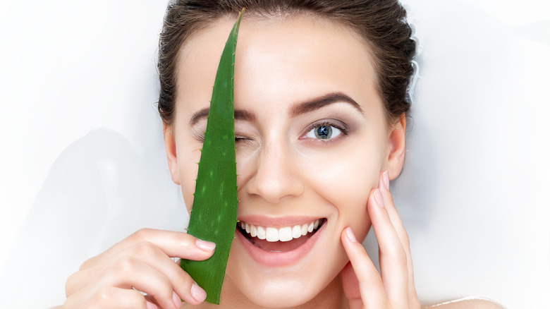 Woman holding aloe vera