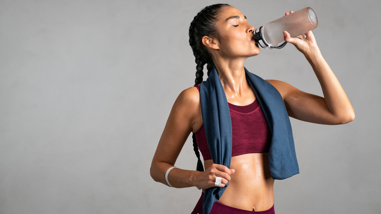 Fitness woman drinking from a water bottle