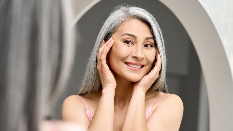 Older woman looking in mirror