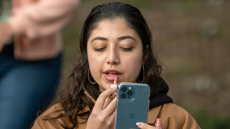 woman applying lipstick