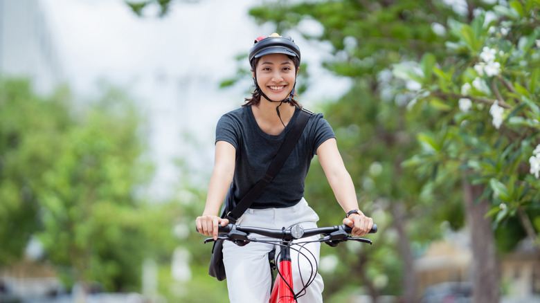 Woman smiling while riding a bike