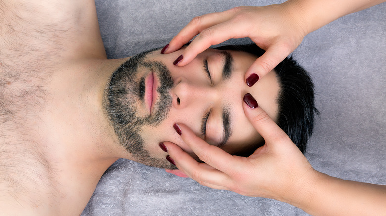 man receiving craniosacral therapy 