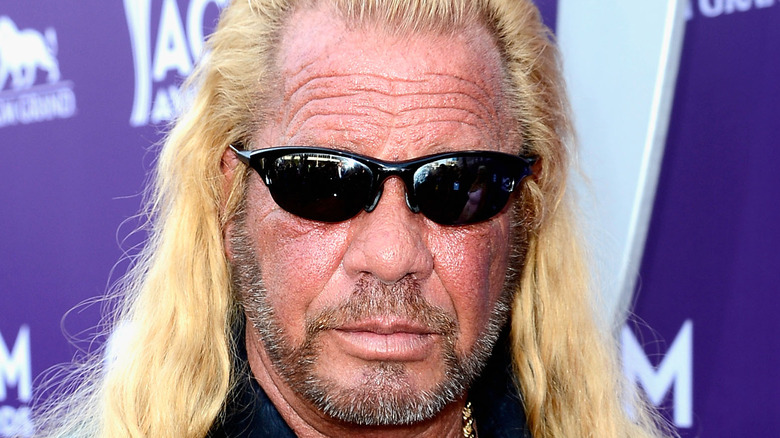 Dog the Bounty Hunter poses at an event