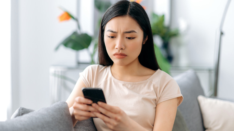 unhappy woman texting