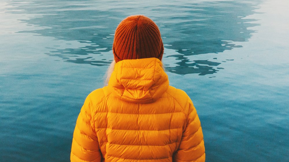 Woman staring into a lake