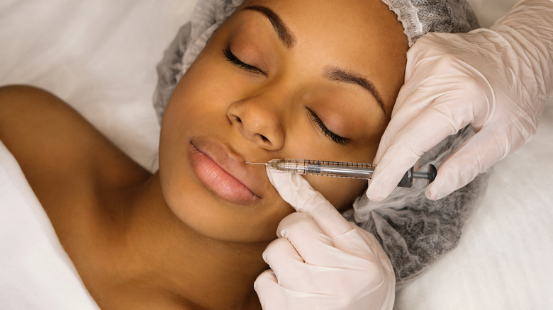 Woman getting lip fillers