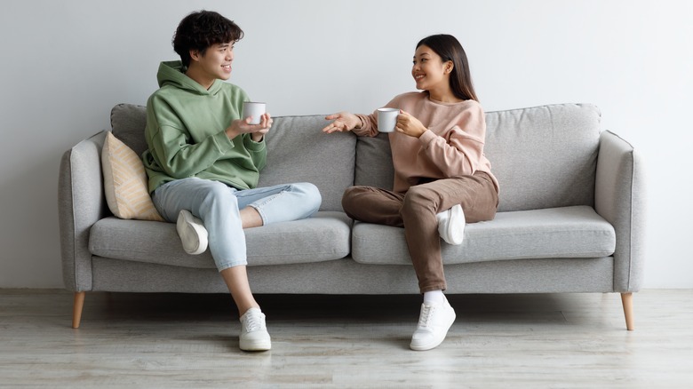 couple sitting in same position on couch