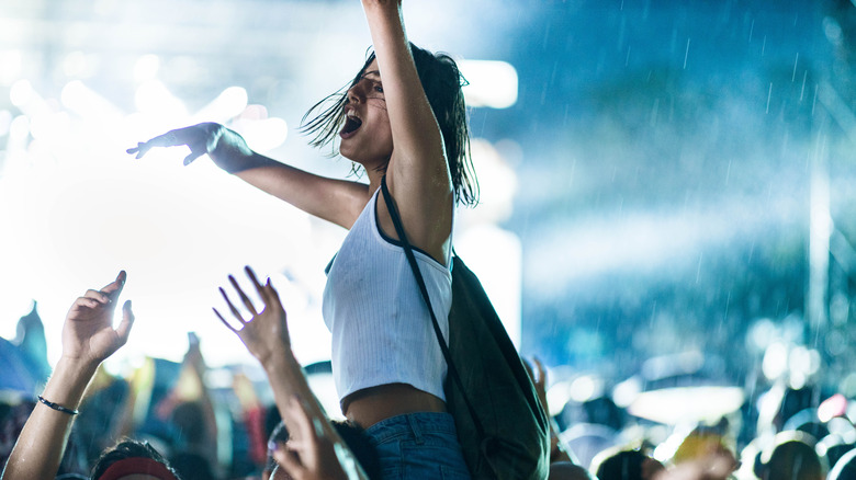 A fan singing along at a concert 