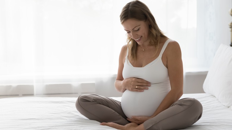 Pregnant woman holding stomach