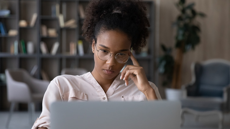 woman looking at her laptop