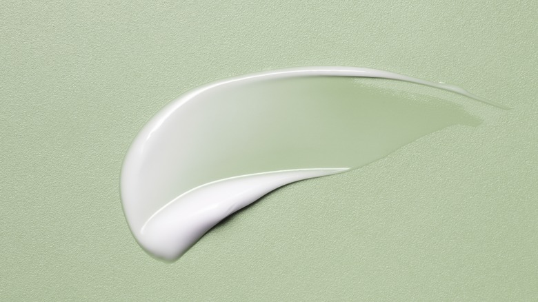 moisturizer swatch on green background