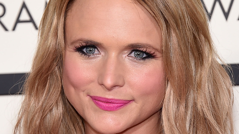 MIranda Lambert grinning in pink lipstick