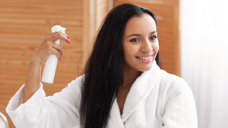 woman spraying tangled hair