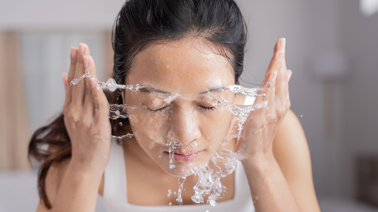 A woman washing her face