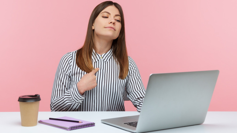 Smug woman with laptop