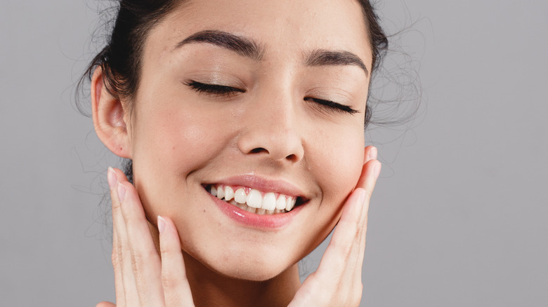 Woman applying skincare 