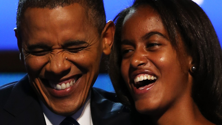 Barack Obama laughs onstage with daughter Malia