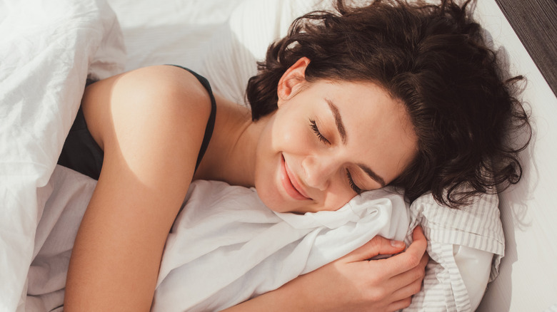 Woman smiling while sleeping