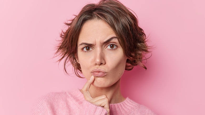 woman thinking about itching