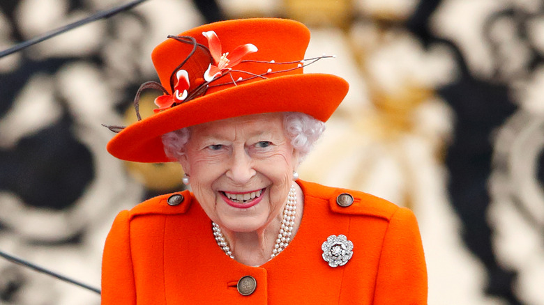 Queen Elizabeth II in a bright orange outfit