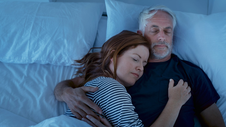 Couple sleeping in bed together
