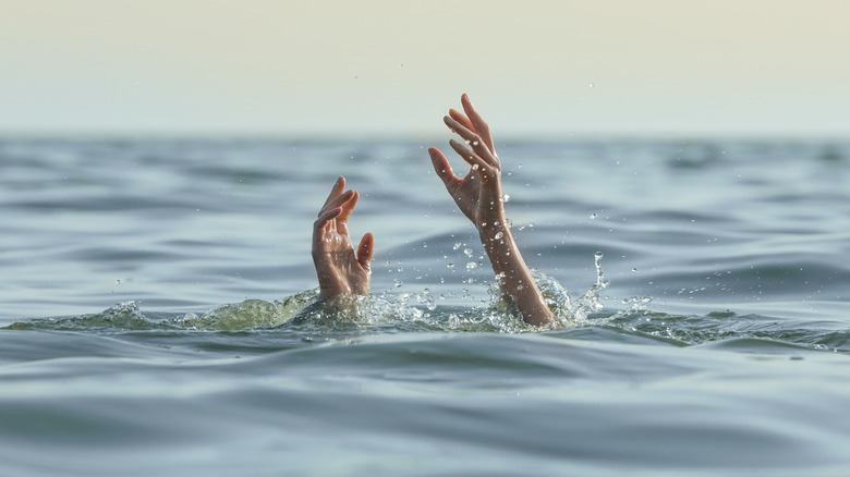 Hands reaching out of the water