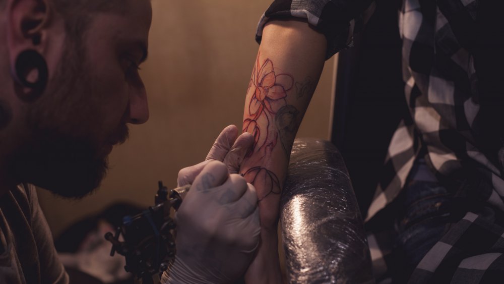 Woman getting a tattoo