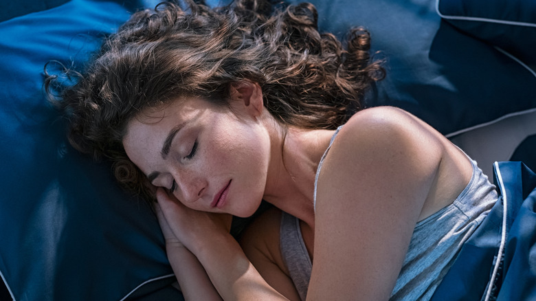 Woman fast asleep in bed