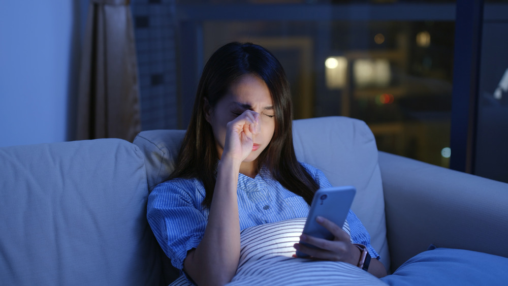 Woman rubbing her eyes