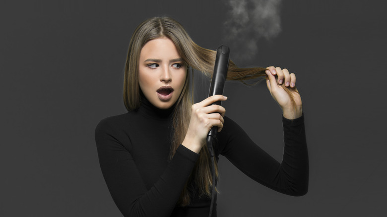 Woman looking at burnt hair