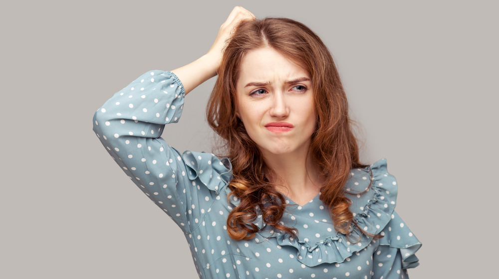 Woman scratching her head