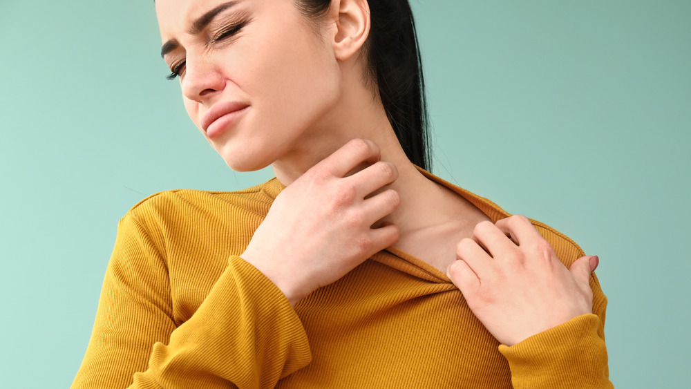 Woman scratching her neck 